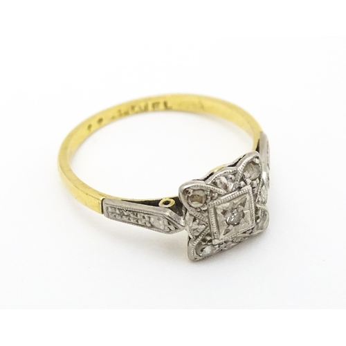 596 - An 18ct gold ring with platinum set diamonds. Ring size approx. M