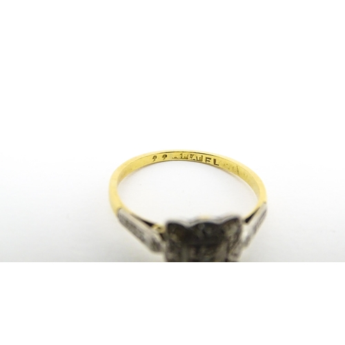 596 - An 18ct gold ring with platinum set diamonds. Ring size approx. M