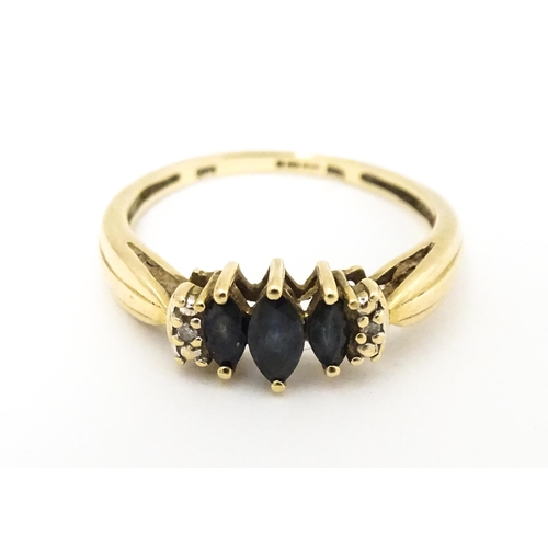 597 - A 9ct gold ring set with sapphires and diamonds. Ring size approx. O