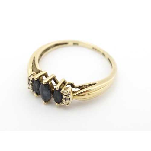 597 - A 9ct gold ring set with sapphires and diamonds. Ring size approx. O