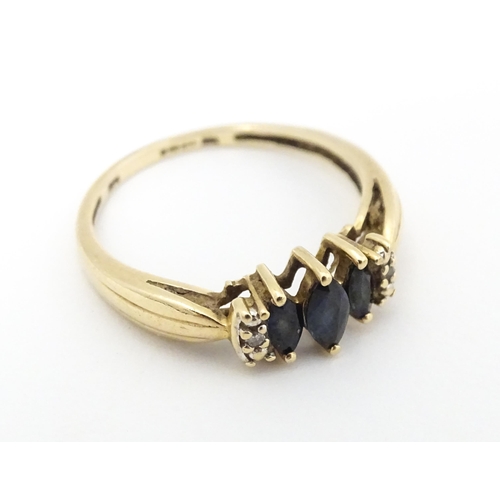 597 - A 9ct gold ring set with sapphires and diamonds. Ring size approx. O