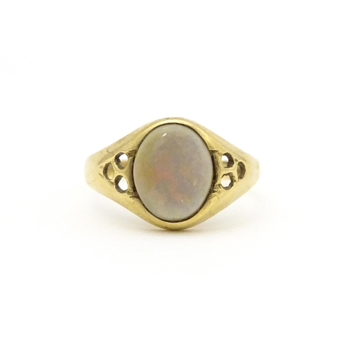 598 - A 9ct gold signet ring set with central opal cabochon. Ring size approx. P