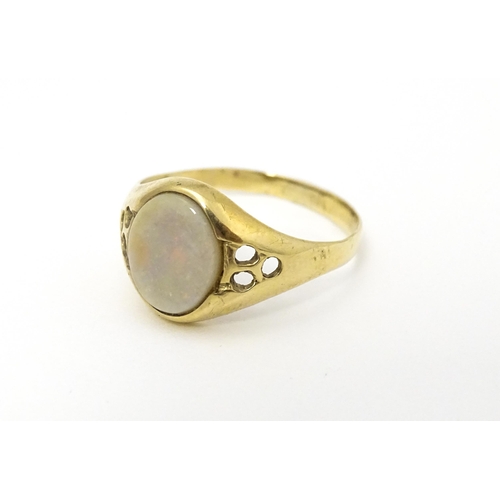 598 - A 9ct gold signet ring set with central opal cabochon. Ring size approx. P