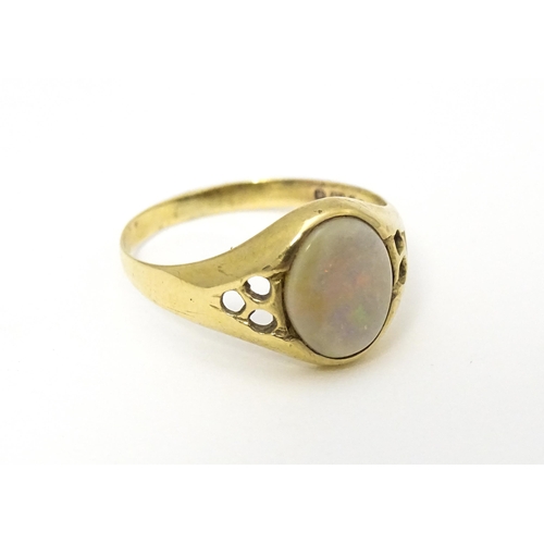 598 - A 9ct gold signet ring set with central opal cabochon. Ring size approx. P