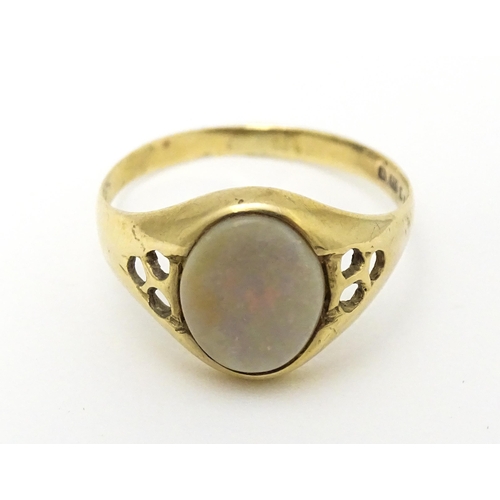 598 - A 9ct gold signet ring set with central opal cabochon. Ring size approx. P