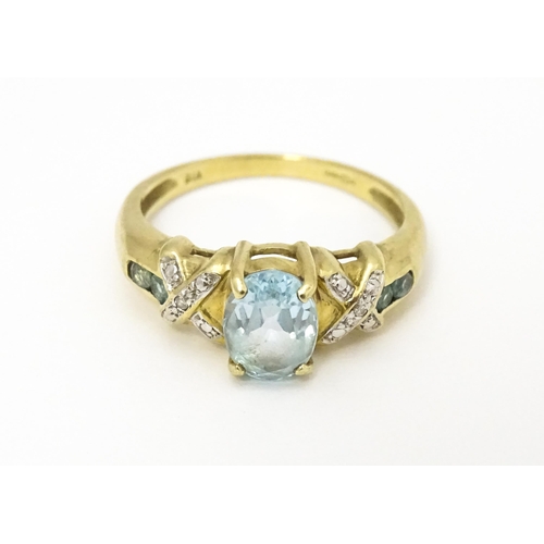 600 - A 9ct gold ring set with aquamarine and diamond. Ring size approx. O