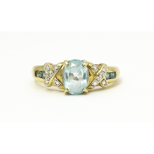 600 - A 9ct gold ring set with aquamarine and diamond. Ring size approx. O