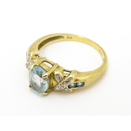 600 - A 9ct gold ring set with aquamarine and diamond. Ring size approx. O