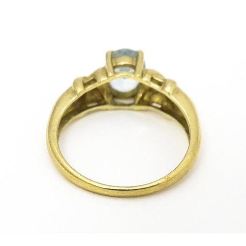 600 - A 9ct gold ring set with aquamarine and diamond. Ring size approx. O