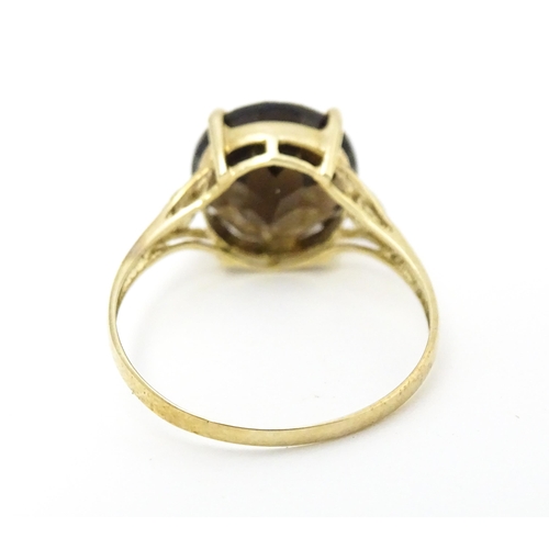 604 - A 9ct gold ring set with smoky topaz and diamonds. Ring size approx. M