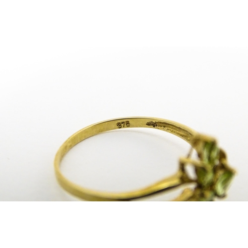 606 - A 9ct gold ring set with peridot and diamonds. Ring size approx. O