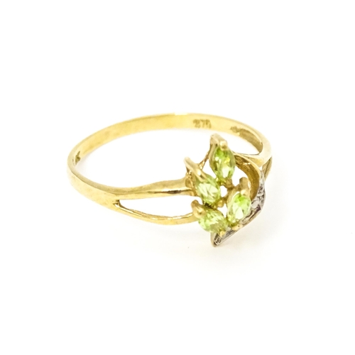 606 - A 9ct gold ring set with peridot and diamonds. Ring size approx. O