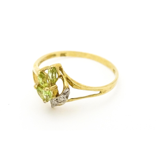 606 - A 9ct gold ring set with peridot and diamonds. Ring size approx. O