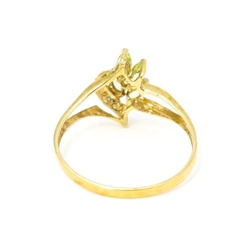 606 - A 9ct gold ring set with peridot and diamonds. Ring size approx. O