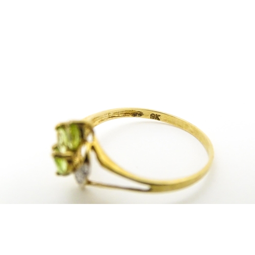 606 - A 9ct gold ring set with peridot and diamonds. Ring size approx. O