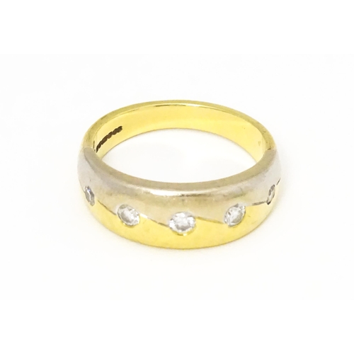 608 - An 18ct white and yellow gold ring set with five diamonds. Ring size approx L