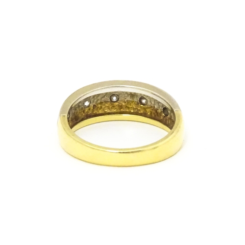 608 - An 18ct white and yellow gold ring set with five diamonds. Ring size approx L