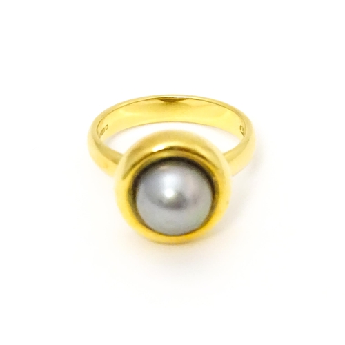 610 - A 18ct gold ring set with Blue Akoya Oyster pearl. Ring size approx. M 1/2