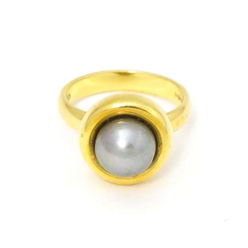 610 - A 18ct gold ring set with Blue Akoya Oyster pearl. Ring size approx. M 1/2