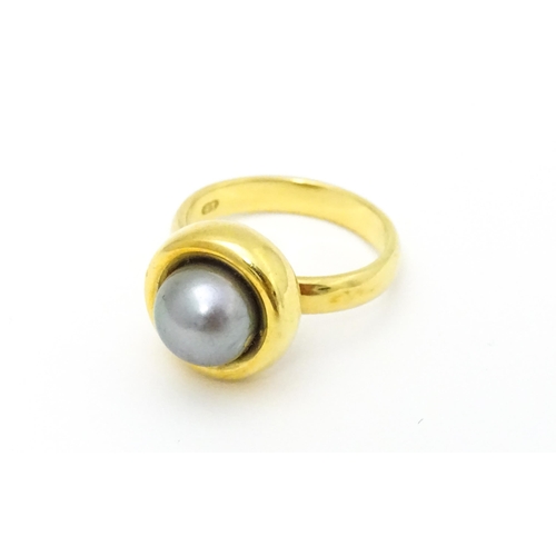 610 - A 18ct gold ring set with Blue Akoya Oyster pearl. Ring size approx. M 1/2