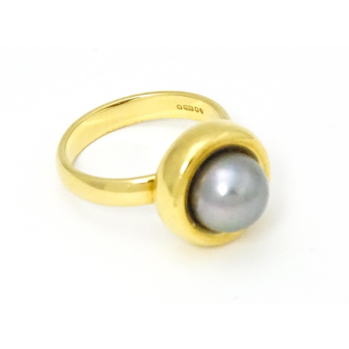 610 - A 18ct gold ring set with Blue Akoya Oyster pearl. Ring size approx. M 1/2