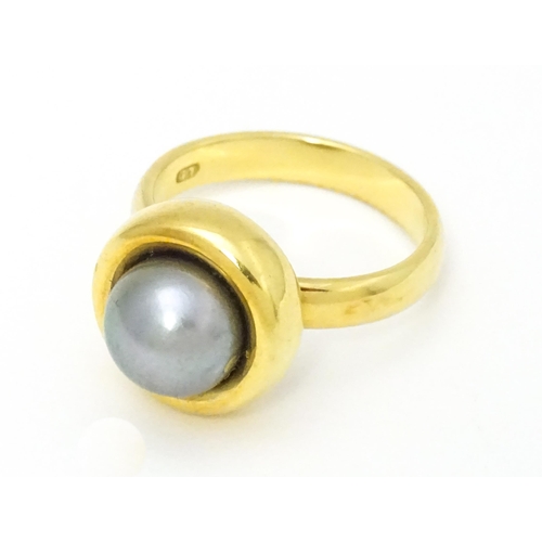 610 - A 18ct gold ring set with Blue Akoya Oyster pearl. Ring size approx. M 1/2