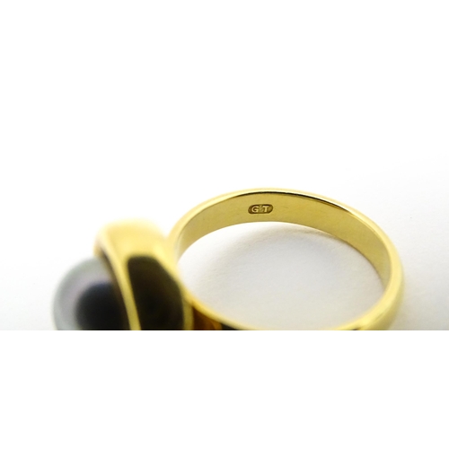 610 - A 18ct gold ring set with Blue Akoya Oyster pearl. Ring size approx. M 1/2