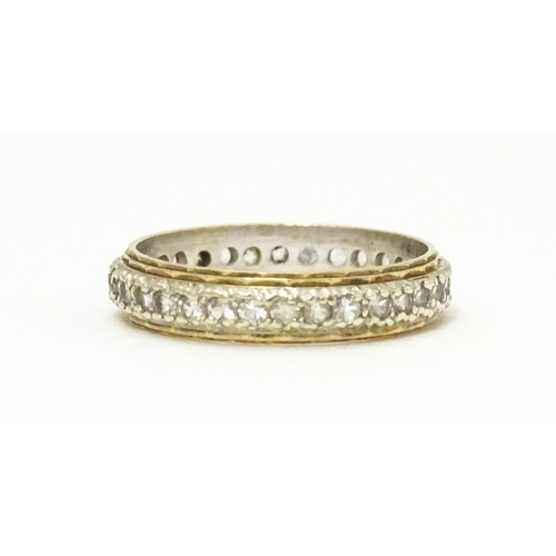 611 - A 9ct gold eternity ring set with white stones. Ring size approx. K 1/2