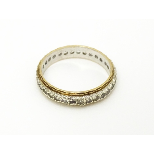 611 - A 9ct gold eternity ring set with white stones. Ring size approx. K 1/2