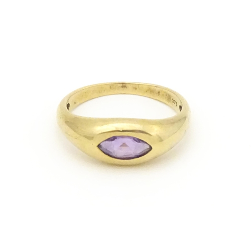 612 - A 9ct gold ring set with central marquise cut amethyst. Ring size approx. N