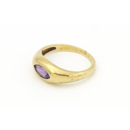 612 - A 9ct gold ring set with central marquise cut amethyst. Ring size approx. N