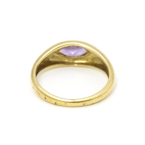 612 - A 9ct gold ring set with central marquise cut amethyst. Ring size approx. N