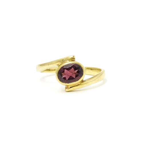 613 - A 9ct gold ring set with oval garnet. Ring size approx. Q