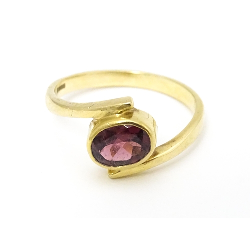 613 - A 9ct gold ring set with oval garnet. Ring size approx. Q