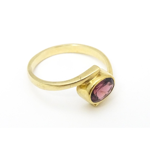 613 - A 9ct gold ring set with oval garnet. Ring size approx. Q