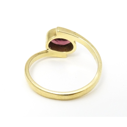 613 - A 9ct gold ring set with oval garnet. Ring size approx. Q