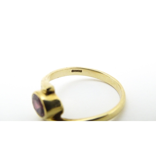 613 - A 9ct gold ring set with oval garnet. Ring size approx. Q