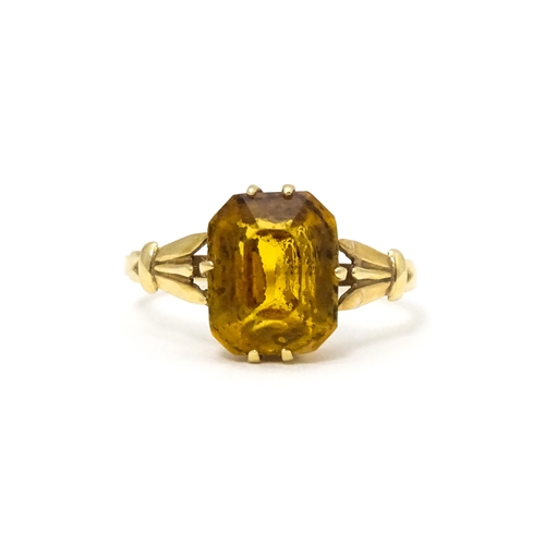 614 - A 9ct gold dress ring set with claw set octagonal cut orange quartz / citrine. Ring size approx. N