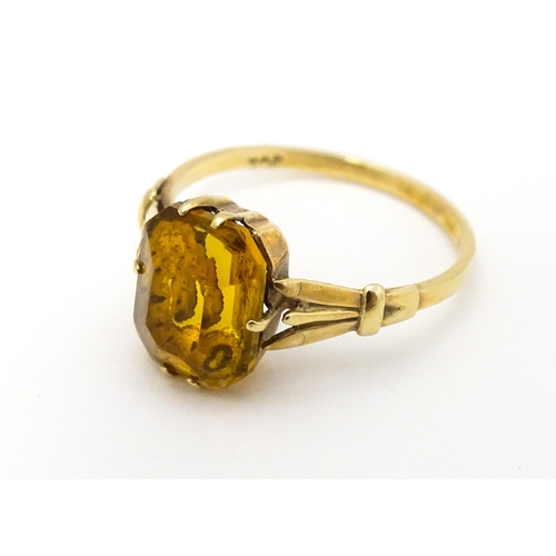 614 - A 9ct gold dress ring set with claw set octagonal cut orange quartz / citrine. Ring size approx. N