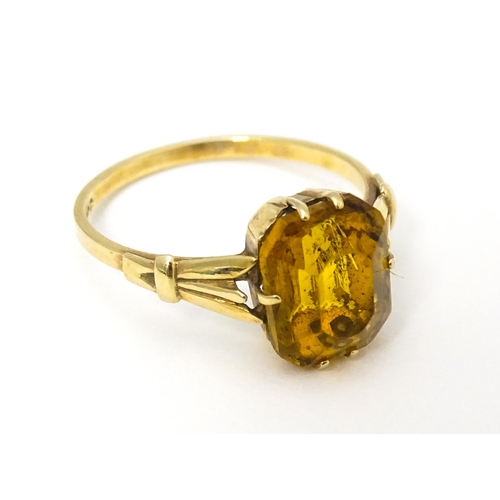 614 - A 9ct gold dress ring set with claw set octagonal cut orange quartz / citrine. Ring size approx. N