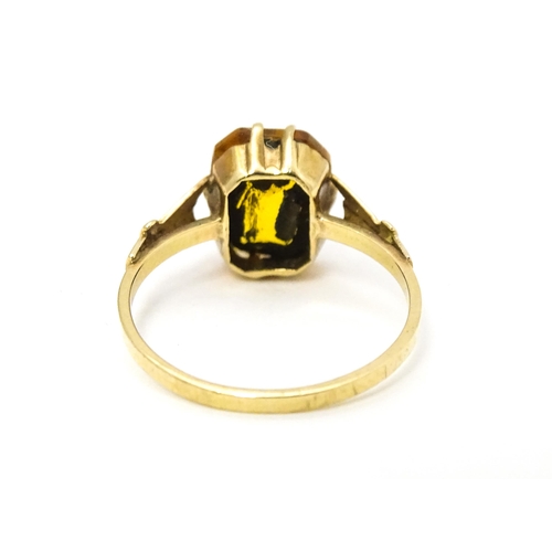 614 - A 9ct gold dress ring set with claw set octagonal cut orange quartz / citrine. Ring size approx. N