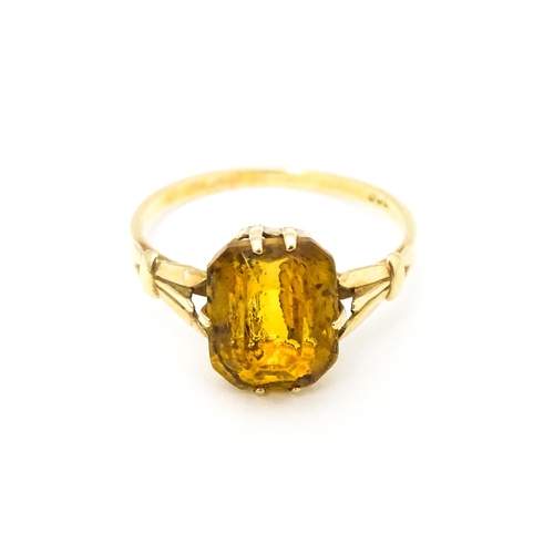 614 - A 9ct gold dress ring set with claw set octagonal cut orange quartz / citrine. Ring size approx. N