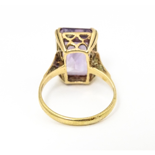 620 - A 9ct gold dress ring set with central amethyst. Ring size approx. J 1/2