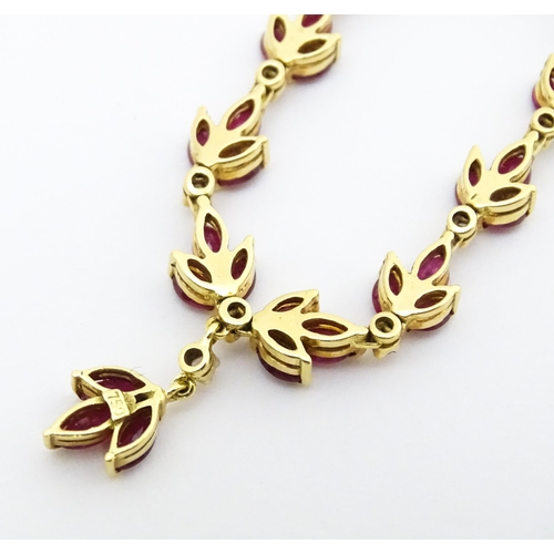 624 - An 18ct gold necklace set with 33 rubies and 10 diamonds. Approx 17