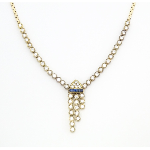 633 - A 14ct gold necklace set with 51 diamonds and a band of 4 sapphires in an Art Deco setting. Approx. ... 