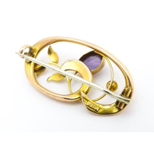 639 - A 9ct gold Art Nouveau brooch set with amethyst. Approx. 1 1/4