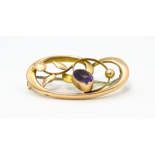 639 - A 9ct gold Art Nouveau brooch set with amethyst. Approx. 1 1/4