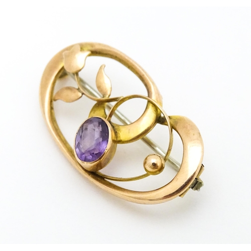 639 - A 9ct gold Art Nouveau brooch set with amethyst. Approx. 1 1/4