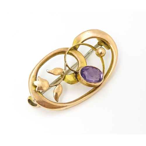 639 - A 9ct gold Art Nouveau brooch set with amethyst. Approx. 1 1/4