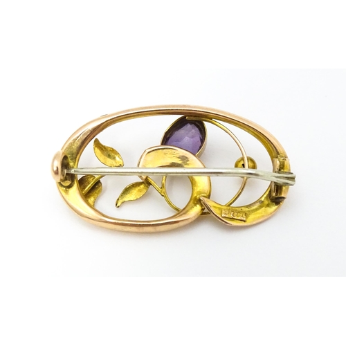 639 - A 9ct gold Art Nouveau brooch set with amethyst. Approx. 1 1/4